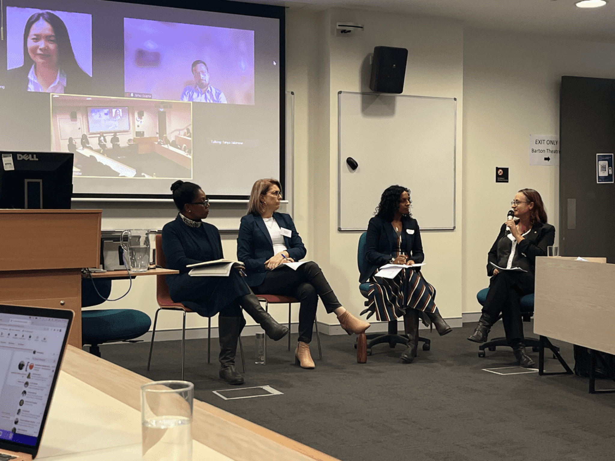 Panellists in front of slides