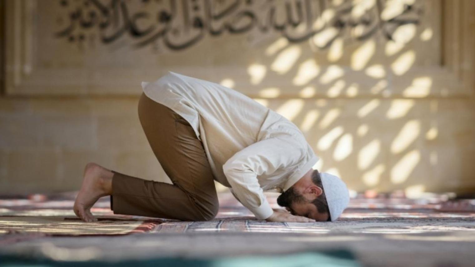 Muslim man praying in a mosque 